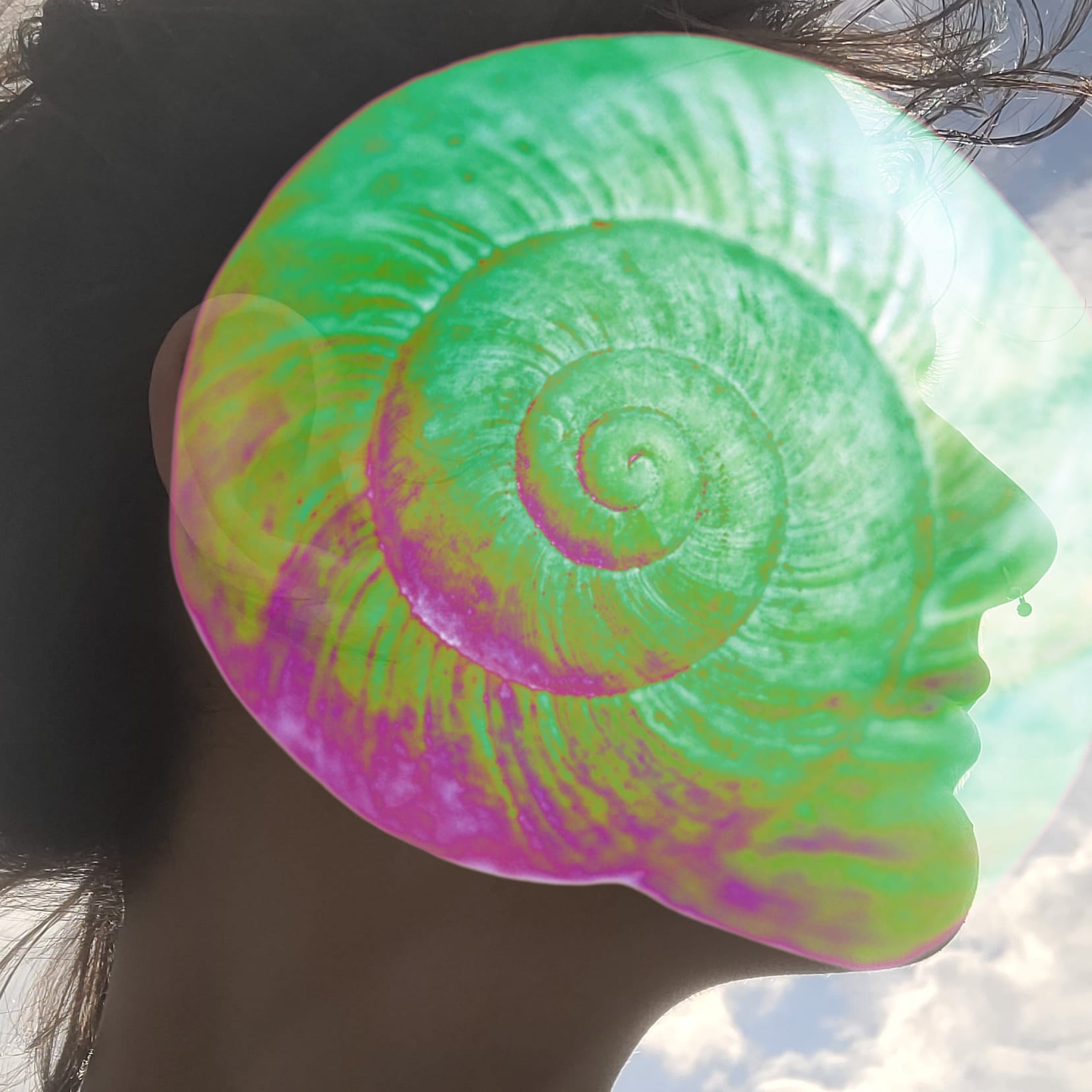 Em in profile, face covered with a glowing shell